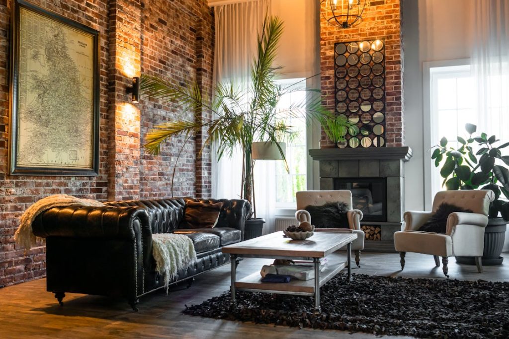 Photo by Polina ⠀ from Pexels: https://www.pexels.com/photo/living-room-with-green-plants-and-brown-sofa-chairs-5644367/